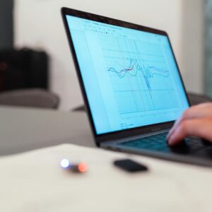A person working on a graph analysis on a laptop for data monitoring and research.